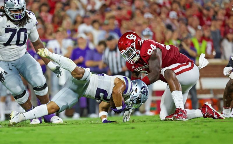 Sep 24, 2022; Norman, Oklahoma, USA;  Oklahoma Sooners defensive lineman Isaiah Coe (94) tackles Kansas State Wildcats running back Deuce Vaughn (22) during the first half at Gaylord Family-Oklahoma Memorial Stadium. Mandatory Credit: Kevin Jairaj-USA TODAY Sports