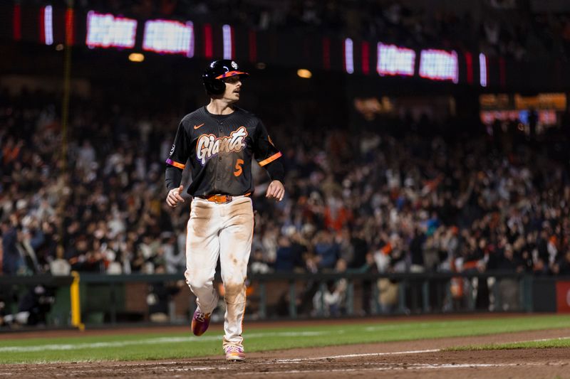 May 13, 2025; San Francisco, California, USA; San Francisco Giants right fielder Mike Yastrzemski (5) runs home to score on a three-run home run by center fielder Jung Hoo Lee (51) during the eighth inning against the Arizona Diamondbacks at Oracle Park. Mandatory Credit: John Hefti-Imagn Images