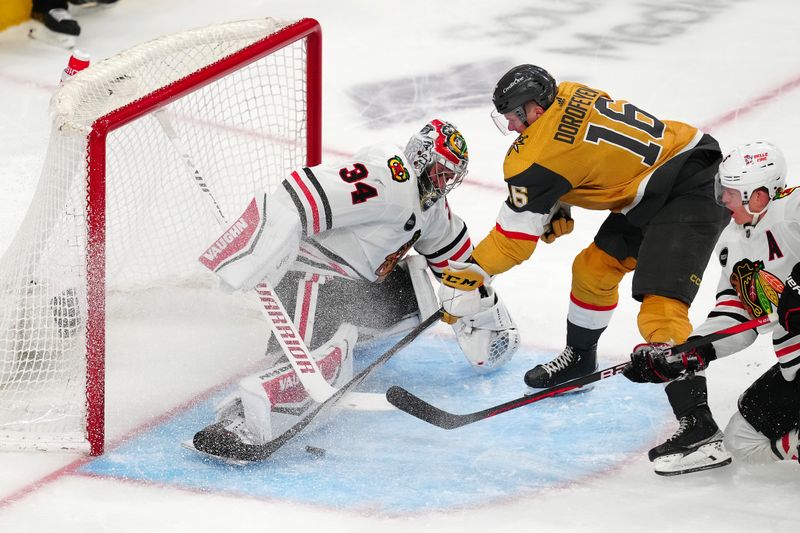 Apr 16, 2024; Las Vegas, Nevada, USA; Chicago Blackhawks goaltender Petr Mrazek (34) makes a save against Vegas Golden Knights left wing Pavel Dorofeyev (16) during the second period at T-Mobile Arena. Mandatory Credit: Stephen R. Sylvanie-USA TODAY Sports