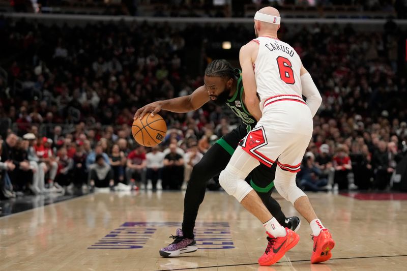 CHICAGO, ILLINOIS - FEBRUARY 22: Jaylen Brown #7 of the Boston Celtics dribbles the ball against Alex Caruso #6 of the Chicago Bulls during the first half at the United Center on February 22, 2024 in Chicago, Illinois. NOTE TO USER: User expressly acknowledges and agrees that, by downloading and or using this photograph, User is consenting to the terms and conditions of the Getty Images License Agreement. (Photo by Patrick McDermott/Getty Images)