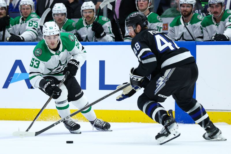 Nov 23, 2024; Tampa, Florida, USA; Dallas Stars center Wyatt Johnston (53) controls the puck from Tampa Bay Lightning defenseman Nick Perbix (48) in the second period at Amalie Arena. Mandatory Credit: Nathan Ray Seebeck-Imagn Images