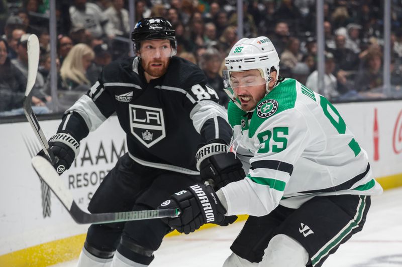 Mar 9, 2024; Los Angeles, California, USA; Dallas Stars center Matt Duchene (95) tries to move the puck as Los Angeles Kings defensemen Vladislav Gavrikov (84) defends during the first period at Crypto.com Arena. Mandatory Credit: Yannick Peterhans-USA TODAY Sports