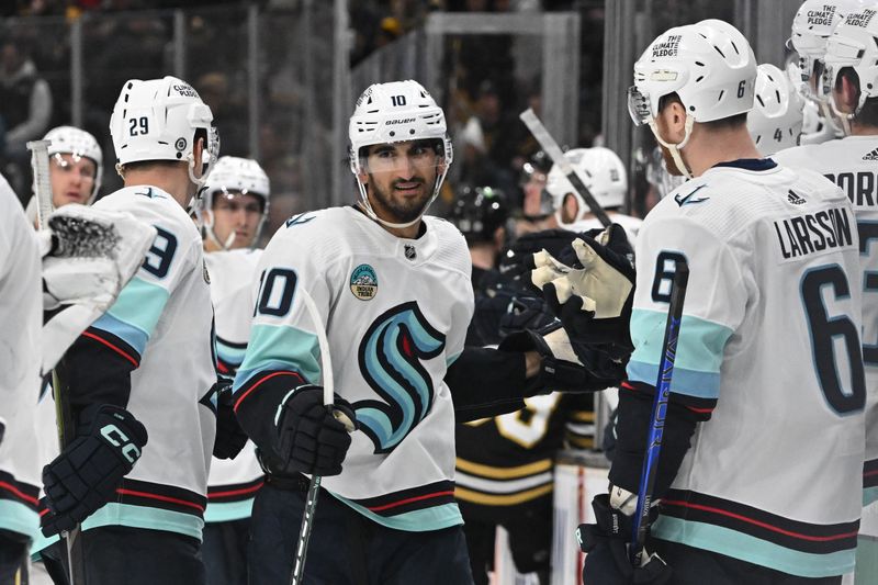 Feb 15, 2024; Boston, Massachusetts, USA; Seattle Kraken center Matty Beniers (10) celebrates after scoring a goal against the Boston Bruins during the third period at the TD Garden. Mandatory Credit: Brian Fluharty-USA TODAY Sports