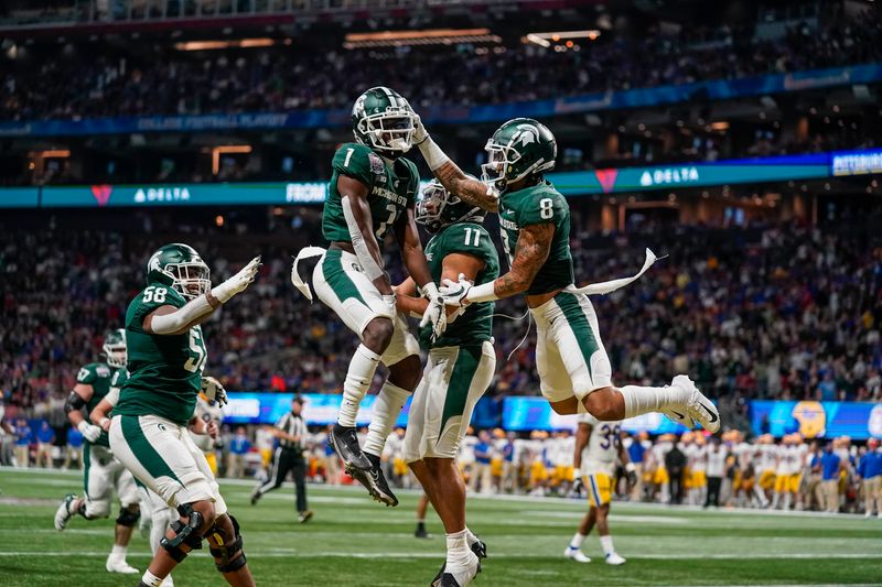 Dec 30, 2021; Atlanta, GA, USA; Michigan State Spartans wide receiver Jayden Reed (1) reacts with teammates after catching a touchdown pass against the Pittsburgh Panthers during the first quarter during the 2021 Peach Bowl at Mercedes-Benz Stadium. Mandatory Credit: Dale Zanine-USA TODAY Sports