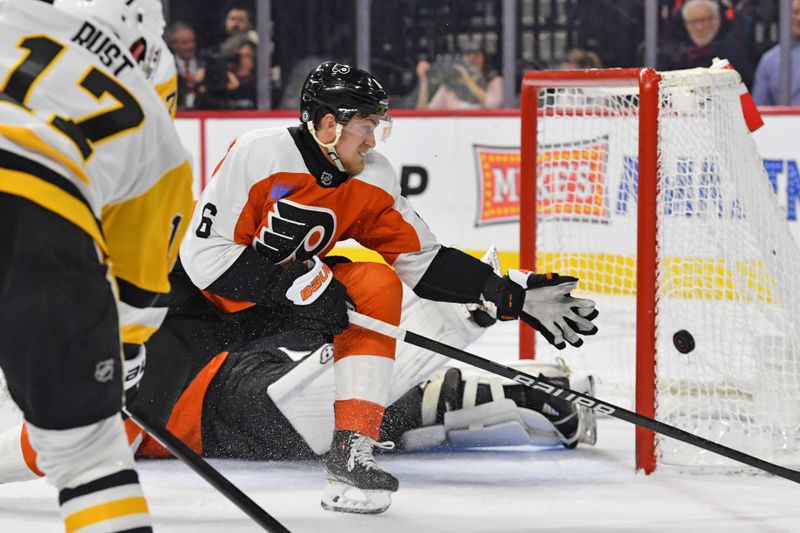 Jan 8, 2024; Philadelphia, Pennsylvania, USA;  Philadelphia Flyers defenseman Travis Sanheim (6) reaches for puck against the Pittsburgh Penguins during the second period at Wells Fargo Center. Mandatory Credit: Eric Hartline-USA TODAY Sports