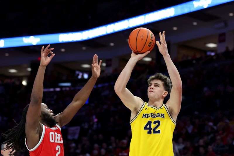 Feb 8, 2026; Columbus, Ohio, USA;  Michigan Wolverines forward Will Tschetter (42) shoots the ball as Ohio State Buckeyes guard Bruce Thornton (2) defends during the first half at Value City Arena. Mandatory Credit: Joseph Maiorana-Imagn Images
