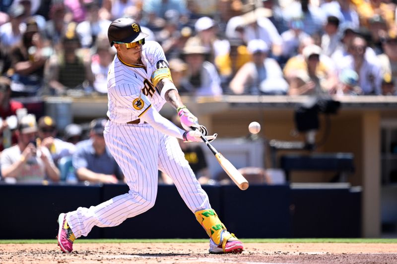 Jul 26, 2023; San Diego, California, USA; San Diego Padres third baseman Manny Machado (13) hits an RBI double against the Pittsburgh Pirates during the third inning at Petco Park. Mandatory Credit: Orlando Ramirez-USA TODAY Sports