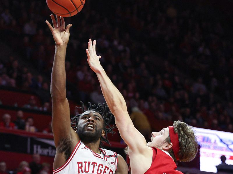 Jan 17, 2024; Piscataway, New Jersey, USA; Rutgers Scarlet Knights guard Austin Williams (24) shoots the ball asNebraska Cornhuskers guard Sam Hoiberg (1) defends during the second half at Jersey Mike's Arena. Mandatory Credit: Vincent Carchietta-USA TODAY Sports