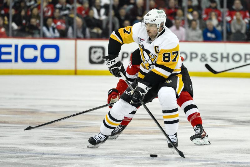 Apr 2, 2024; Newark, New Jersey, USA; Pittsburgh Penguins center Sidney Crosby (87) skates with the puck while being defended by New Jersey Devils defenseman Brendan Smith (2) during the third period at Prudential Center. Mandatory Credit: John Jones-USA TODAY Sports