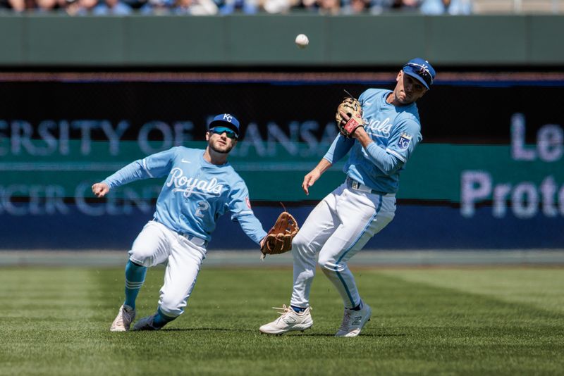 Apr 21, 2024; Kansas City, Missouri, USA; Kansas City Royals outfielder Garrett Hampson (2) and Kansas City Royals second base Adam Frazier (26) collide in the outfield going after a fly ball during the second inning against the Baltimore Orioles at Kauffman Stadium. Mandatory Credit: William Purnell-USA TODAY Sports