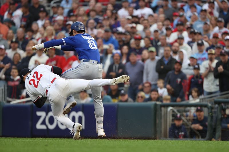 Oct 4, 2023; Minneapolis, Minnesota, USA; Minnesota Twins relief pitcher Griffin Jax (22) tags out Toronto Blue Jays second baseman Cavan Biggio (8) in the eighth inning  during game two of the Wildcard series for the 2023 MLB playoffs at Target Field. Mandatory Credit: Jesse Johnson-USA TODAY Sports