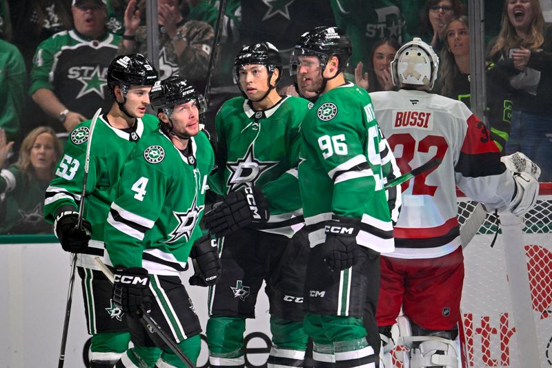 Oct 25, 2025; Dallas, Texas, USA; Dallas Stars defenseman Miro Heiskanen (4) and center Wyatt Johnston (53) and left wing Jason Robertson (21) and right wing Mikko Rantanen (96) celebrates the game winning goal by Heiskanen against Carolina Hurricanes goaltender Brandon Bussi (32) during the third period at the American Airlines Center. Mandatory Credit: Jerome Miron-Imagn Images