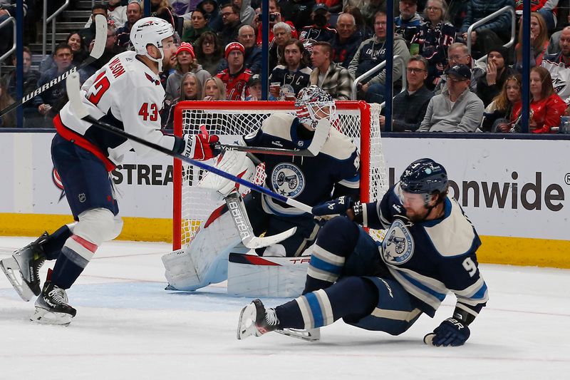 Dec 21, 2023; Columbus, Ohio, USA; Columbus Blue Jackets defenseman Ivan Provorov (9) falls to the ice after blocking a Washington Capitals shot attempt during the second period at Nationwide Arena. Mandatory Credit: Russell LaBounty-USA TODAY Sports