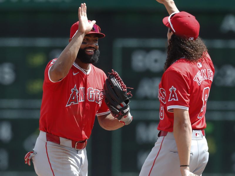 May 8, 2024; Pittsburgh, Pennsylvania, USA;  Los Angeles Angels right fielder Jo Adell (7) and third baseman shortstop Cole Tucker (8) celebrate after defeating the Pittsburgh Pirates at PNC Park. Mandatory Credit: Charles LeClaire-USA TODAY Sports