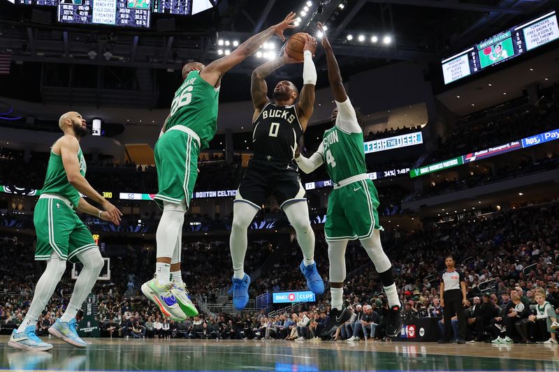 MILWAUKEE, WISCONSIN - APRIL 09: Damian Lillard #0 of the Milwaukee Bucks is defended by Xavier Tillman #26 of the Boston Celtics during a game at Fiserv Forum on April 09, 2024 in Milwaukee, Wisconsin. NOTE TO USER: User expressly acknowledges and agrees that, by downloading and or using this photograph, User is consenting to the terms and conditions of the Getty Images License Agreement. (Photo by Stacy Revere/Getty Images)