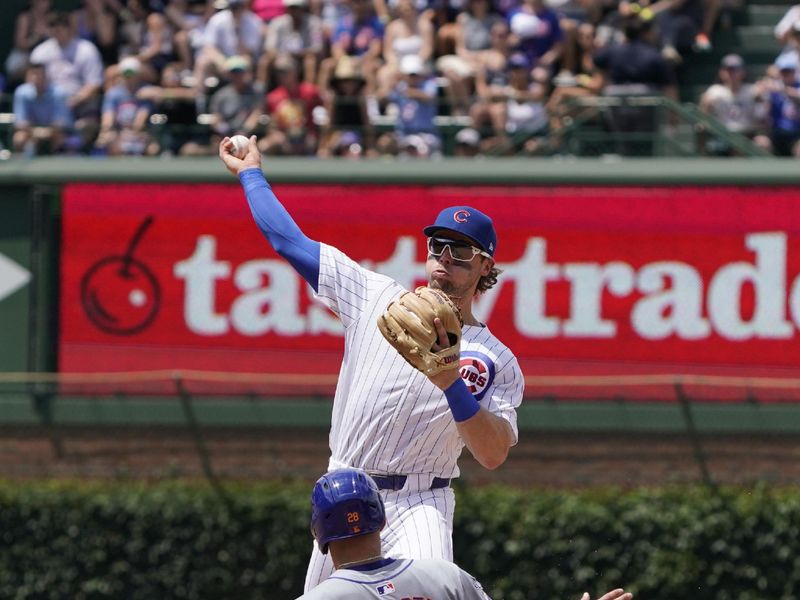 Jun 22, 2024; Chicago, Illinois, USA; Chicago Cubs second baseman Nico Hoerner (2) forces out New York Mets first baseman Pete Alonso (20) at second base during the fourth inning at Wrigley Field. Mandatory Credit: David Banks-USA TODAY Sports