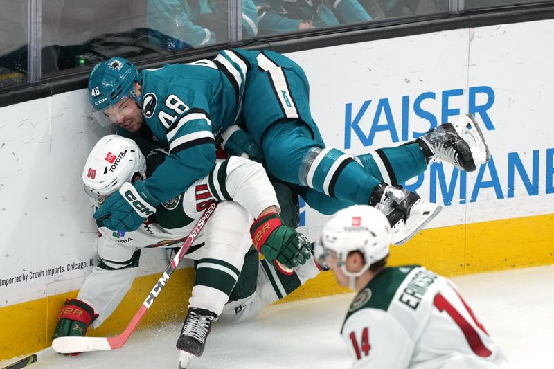 Mar 11, 2023; San Jose, California, USA; San Jose Sharks center Tomas Hertl (48) collides with Minnesota Wild left wing Marcus Johansson (90) during the third period at SAP Center at San Jose. Mandatory Credit: Darren Yamashita-USA TODAY Sports