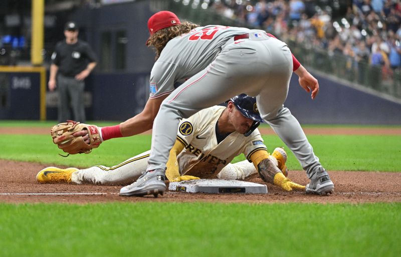 Sep 16, 2024; Milwaukee, Wisconsin, USA; Milwaukee Brewers third base Joey Ortiz (3) slides safely into third base for a triple ahead of the tag by Philadelphia Phillies third base Alec Bohm (28) in the sixth inning at American Family Field. Mandatory Credit: Michael McLoone-Imagn Images