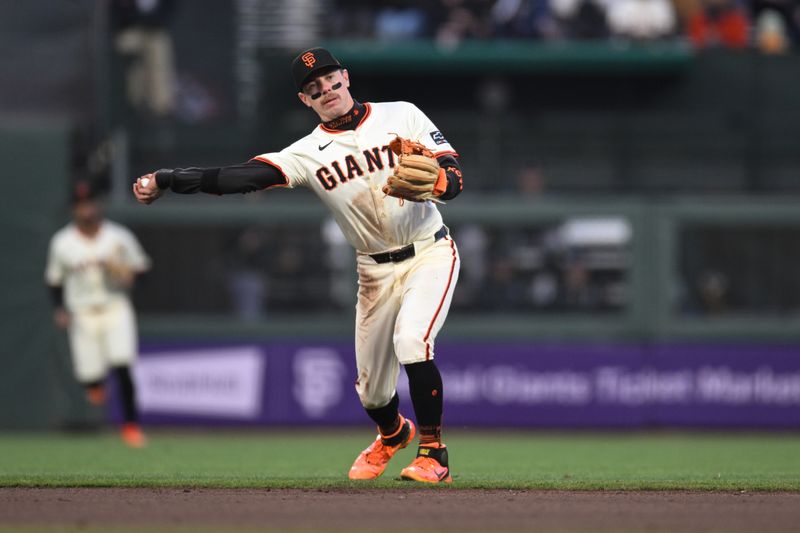 May 1, 2025; San Francisco, California, USA; San Francisco Giants second baseman Christian Koss (50) throws to first base for an out against the Colorado Rockies in the fourth inning at Oracle Park. Mandatory Credit: Eakin Howard-Imagn Images