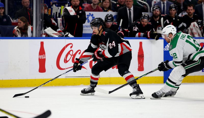 Feb 6, 2024; Buffalo, New York, USA;  Buffalo Sabres center Dylan Cozens (24) controls the puck as Dallas Stars center Radek Faksa (12) defends during the second period at KeyBank Center. Mandatory Credit: Timothy T. Ludwig-USA TODAY Sports