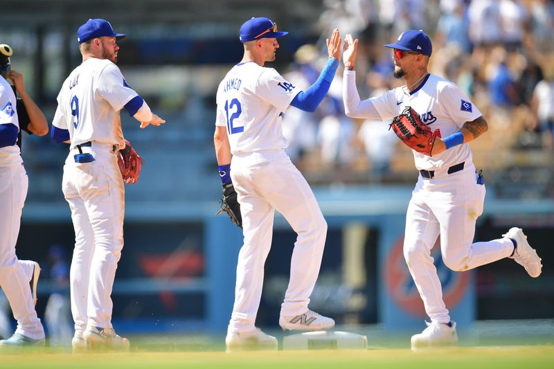 Jul 25, 2024; Los Angeles, California, USA; Los Angeles Dodgers second baseman Gavin Lux (9) shortstop Nick Ahmed (12) and center fielder Andy Pages (44) celebrate the victory against the San Francisco Giants at Dodger Stadium. Mandatory Credit: Gary A. Vasquez-USA TODAY Sports