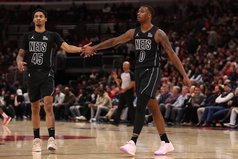 CHICAGO, ILLINOIS - DECEMBER 02: Keon Johnson #45 and Dariq Whitehead #0 of the Brooklyn Nets high five against the Chicago Bulls during the second half at the United Center on December 02, 2024 in Chicago, Illinois. NOTE TO USER: User expressly acknowledges and agrees that, by downloading and or using this photograph, User is consenting to the terms and conditions of the Getty Images License Agreement.  (Photo by Michael Reaves/Getty Images)