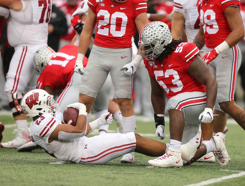 Oct 26, 2019; Columbus, OH, USA; Ohio State Buckeyes defensive tackle Davon Hamilton (53) stops Wisconsin Badgers running back Jonathan Taylor (23) for no gain during the first quarter at Ohio Stadium. Mandatory Credit: Joe Maiorana-USA TODAY Sports