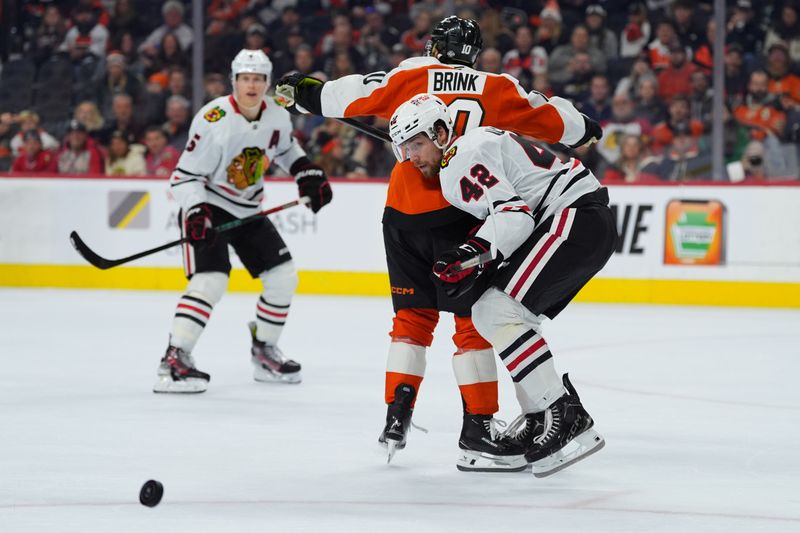 Nov 23, 2024; Philadelphia, Pennsylvania, USA; Chicago Blackhawks defenseman Nolan Allan (42) collides with Philadelphia Flyers right wing Bobby Brink (10) in the first period at Wells Fargo Center. Mandatory Credit: Kyle Ross-Imagn Images