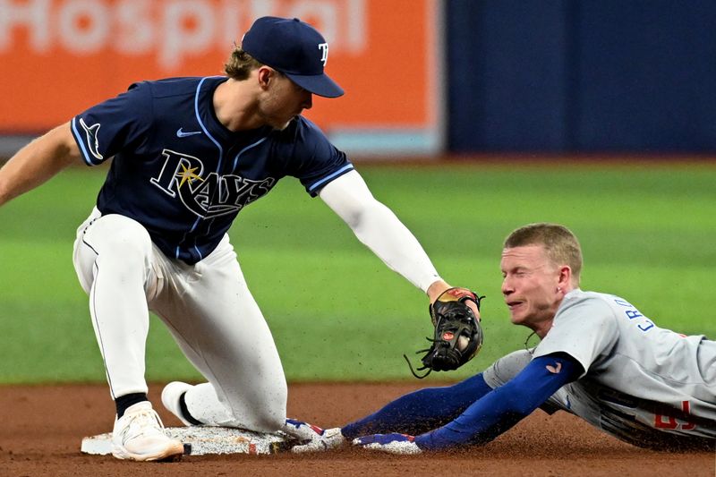 Jun 11, 2024; St. Petersburg, Florida, USA; Chicago Cubs center fielder Pete Crow-Armstrong (52) slides under the tag of Tampa Bay Rays shortstop Taylor Walls (6) in the fifth inning at Tropicana Field. Mandatory Credit: Jonathan Dyer-USA TODAY Sports