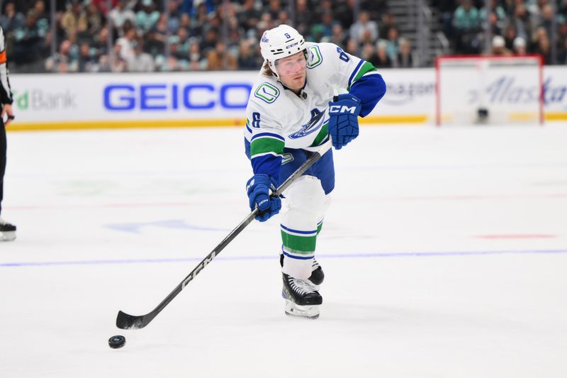 Feb 22, 2024; Seattle, Washington, USA; Vancouver Canucks right wing Brock Boeser (6) shoots the puck against the Seattle Kraken during the third period at Climate Pledge Arena. Mandatory Credit: Steven Bisig-USA TODAY Sports