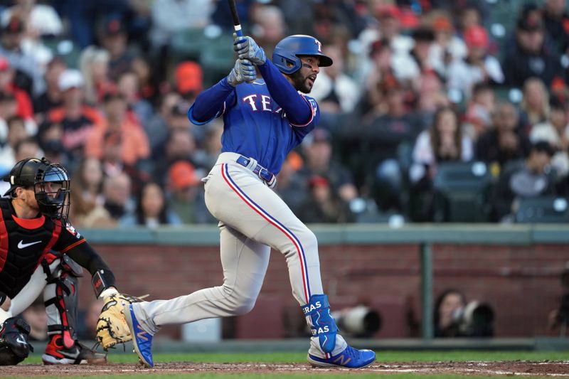 Aug 12, 2023; San Francisco, California, USA; Texas Rangers center fielder Leody Taveras (3) hits an RBI single against the San Francisco Giants during the fourth inning at Oracle Park. Mandatory Credit: Darren Yamashita-USA TODAY Sports