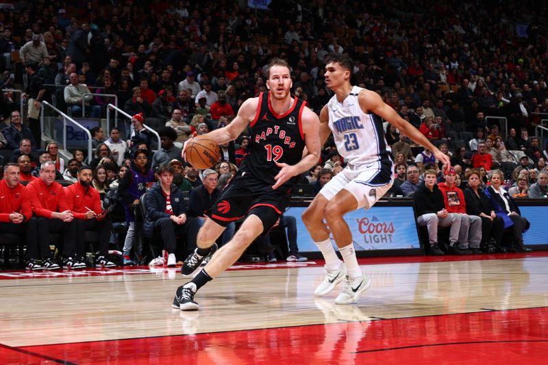 TORONTO, CANADA - JANUARY 3: Jakob Poeltl #19 of the Toronto Raptors drives to the basket during the game against the Orlando Magic on January 3, 2025 at the Scotiabank Arena in Toronto, Ontario, Canada.  NOTE TO USER: User expressly acknowledges and agrees that, by downloading and or using this Photograph, user is consenting to the terms and conditions of the Getty Images License Agreement.  Mandatory Copyright Notice: Copyright 2025 NBAE (Photo by Vaughn Ridley/NBAE via Getty Images)