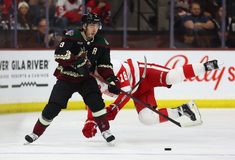 Jan 17, 2023; Tempe, Arizona, USA; Arizona Coyotes right wing Clayton Keller (9) moves the puck against Detroit Red Wings center Andrew Copp (18) in the first period at Mullett Arena. Mandatory Credit: Mark J. Rebilas-USA TODAY Sports
