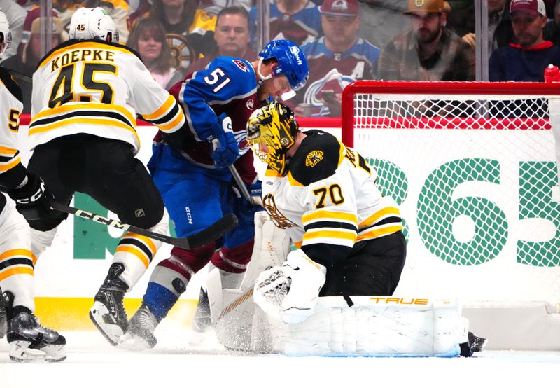 Oct 16, 2024; Denver, Colorado, USA; Boston Bruins goaltender Joonas Korpisalo (70) makes a save on Colorado Avalanche right wing Nikolai Kovalenko (51) in the first period at Ball Arena. Mandatory Credit: Ron Chenoy-Imagn Images