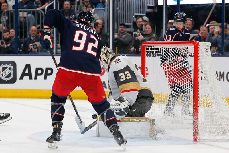 Mar 4, 2024; Columbus, Ohio, USA; Vegas Golden Knights goalie Adin Hill (33) makes a save as Columbus Blue Jackets left wing Alexander Nylander (92) looks for a rebound during the second period at Nationwide Arena. Mandatory Credit: Russell LaBounty-USA TODAY Sports