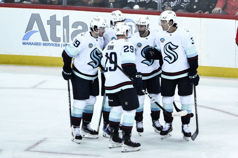 Feb 12, 2024; Newark, New Jersey, USA; Seattle Kraken defenseman Will Borgen (3) celebrates with teammates after scoring a goal against the New Jersey Devils during the third period at Prudential Center. Mandatory Credit: John Jones-USA TODAY Sports