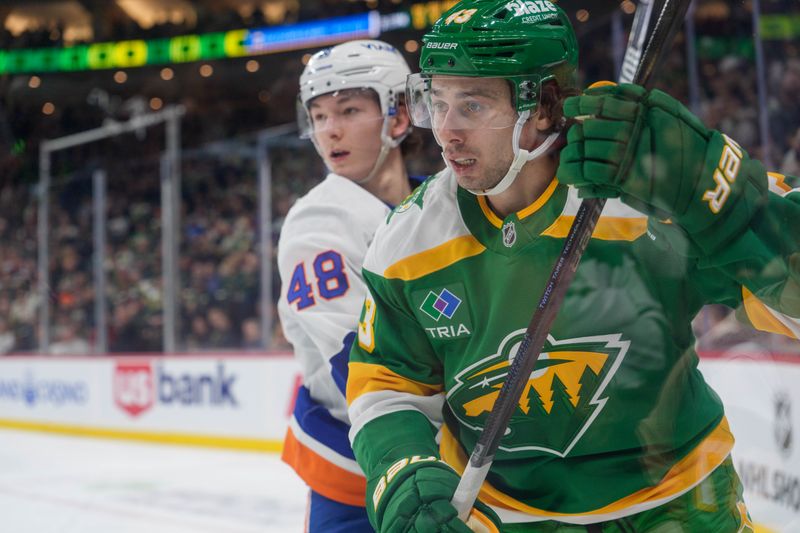Jan 10, 2026; Saint Paul, Minnesota, USA; Minnesota Wild defenseman Quinn Hughes (43) skates by the check of New York Islanders defenseman Matthew Schaefer (48) in the second period at Grand Casino Arena. Mandatory Credit: Matt Blewett-Imagn Images