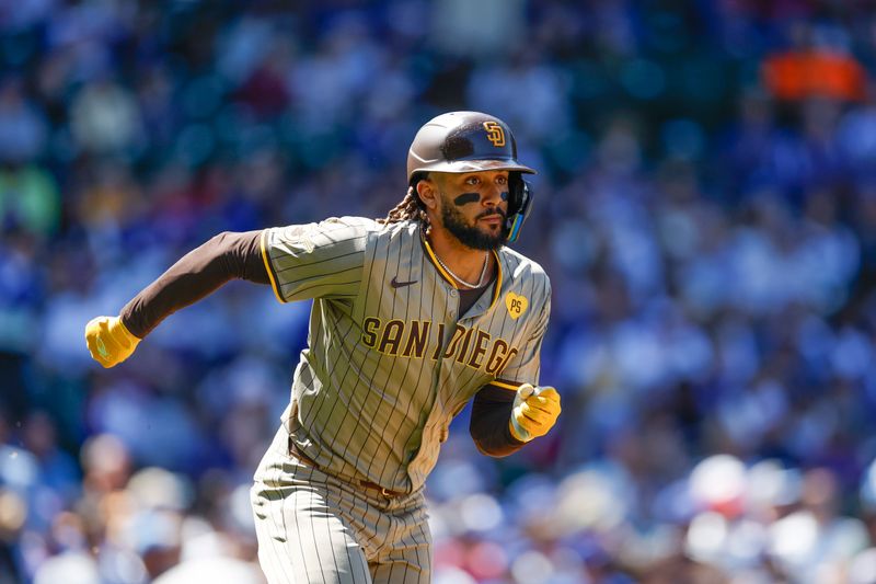 May 8, 2024; Chicago, Illinois, USA; San Diego Padres outfielder Fernando Tatis Jr. (23) runs to first base after hitting an RBI-single against the Chicago Cubs during the fifth inning at Wrigley Field. Mandatory Credit: Kamil Krzaczynski-USA TODAY Sports