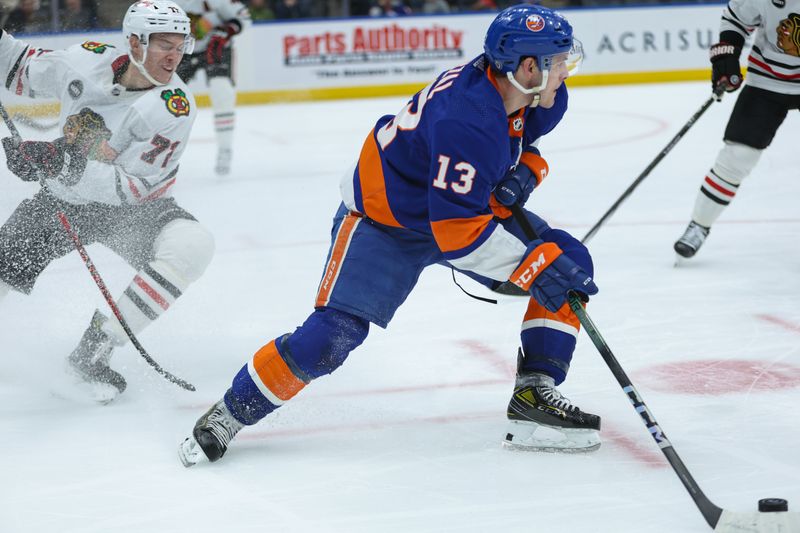 Apr 2, 2024; Elmont, New York, USA; New York Islanders center Mathew Barzal (13) skates with the puck against the Chicago Blackhawks during the second period at UBS Arena. Mandatory Credit: Thomas Salus-USA TODAY Sports