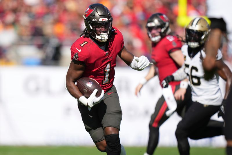 Tampa Bay Buccaneers running back Rachaad White (1) eyes a defender as he rushes during an NFL football game against the New Orleans Saints, Sunday, Dec. 31, 2023, in Tampa, Fla. (AP Photo/Peter Joneleit)