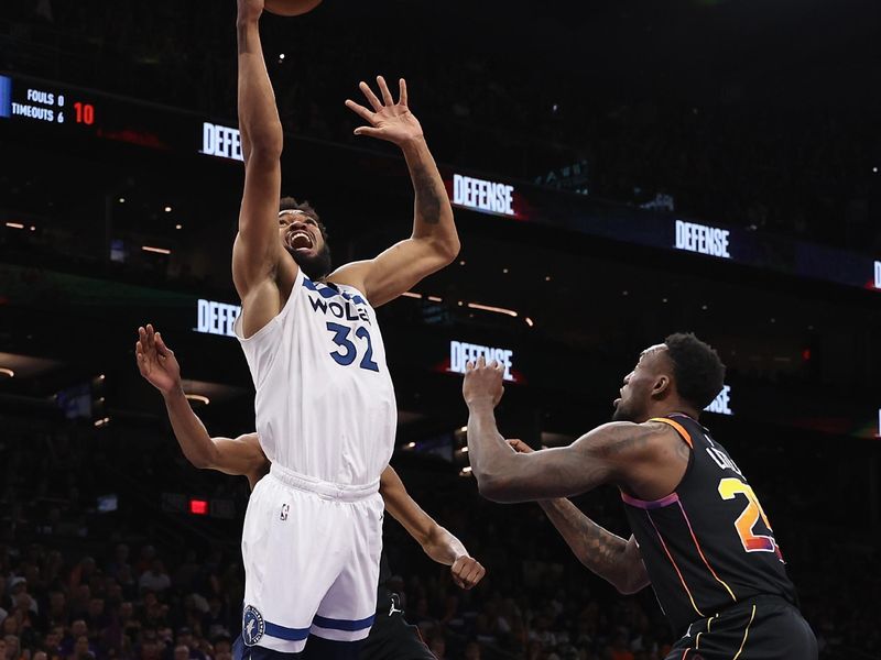 PHOENIX, ARIZONA - APRIL 28: Karl-Anthony Towns #32 of the Minnesota Timberwolves attempts a shot against Nassir Little #25 of the Phoenix Suns during the first half of game four of the Western Conference First Round Playoffs at Footprint Center on April 28, 2024 in Phoenix, Arizona. NOTE TO USER: User expressly acknowledges and agrees that, by downloading and or using this photograph, User is consenting to the terms and conditions of the Getty Images License Agreement.  (Photo by Christian Petersen/Getty Images)