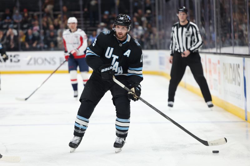 Nov 18, 2024; Salt Lake City, Utah, USA; Utah Hockey Club center Alexander Kerfoot (15) skates with the puck against against the Washington Capitals during the second period at Delta Center. Mandatory Credit: Rob Gray-Imagn Images