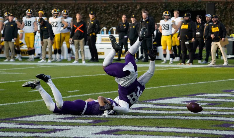 Nov 4, 2023; Chicago, Illinois, USA; Northwestern Wildcats defensive back Braden Turner (28) tries to stop the ball from going into the end zone against the Iowa Hawkeyes during the second half at Wrigley Field. Mandatory Credit: David Banks-USA TODAY Sports