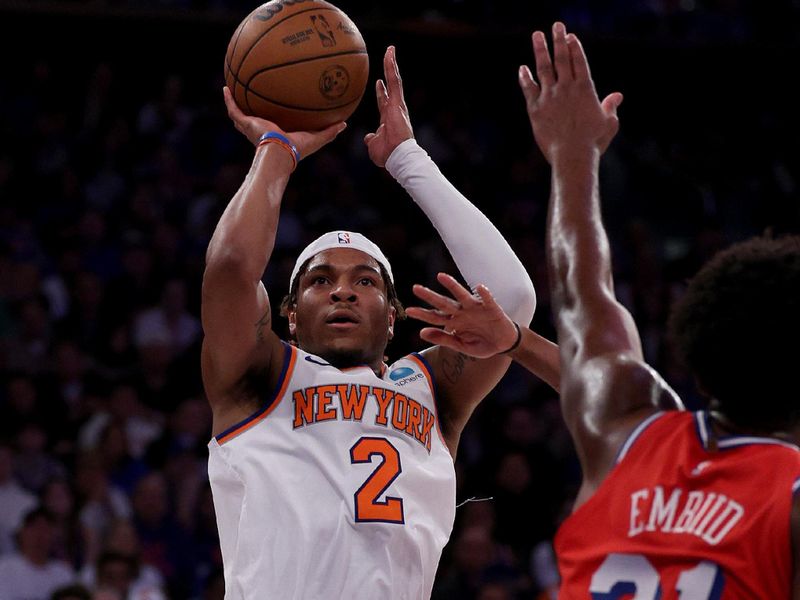 NEW YORK, NEW YORK - APRIL 20: Miles McBride #2 of the New York Knicks takes a shot as Joel Embiid #21 of the Philadelphia 76ers defends during the second half in game one of the Eastern Conference First Round Playoffs at Madison Square Garden on April 20, 2024 in New York City. The New York Knicks defeated the Philadelphia 76ers 111-104. NOTE TO USER: User expressly acknowledges and agrees that, by downloading and or using this photograph, User is consenting to the terms and conditions of the Getty Images License Agreement. (Photo by Elsa/Getty Images)