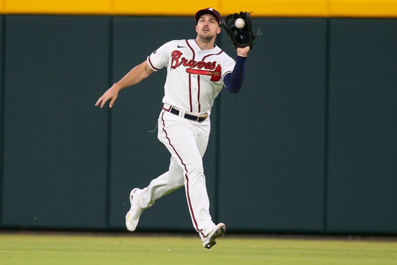 Apr 11, 2022; Atlanta, Georgia, USA; Atlanta Braves right fielder Adam Duvall (14) catches a fly ball against the Washington Nationals in the ninth inning at Truist Park. Mandatory Credit: Brett Davis-USA TODAY Sports