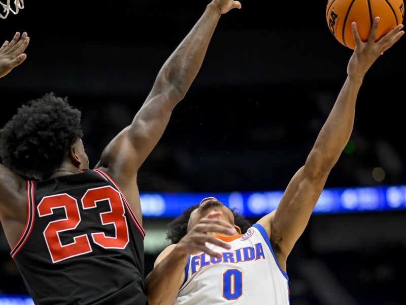 Mar 14, 2024; Nashville, TN, USA;  Florida Gators guard Zyon Pullin (0) shoots over Georgia Bulldogs forward Jalen DeLoach (23) during the second half at Bridgestone Arena. Mandatory Credit: Steve Roberts-USA TODAY Sports