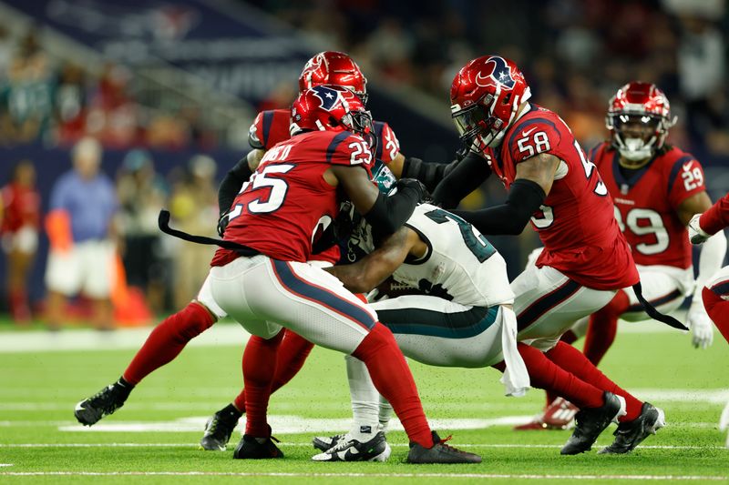 Houston Texans linebacker Christian Kirksey (58) combines on the tackle with Desmond King II (25) during an NFL Football game against the Philadelphia Eagles on Thursday, November 3, 2022, in Houston. (AP Photo/Matt Patterson)