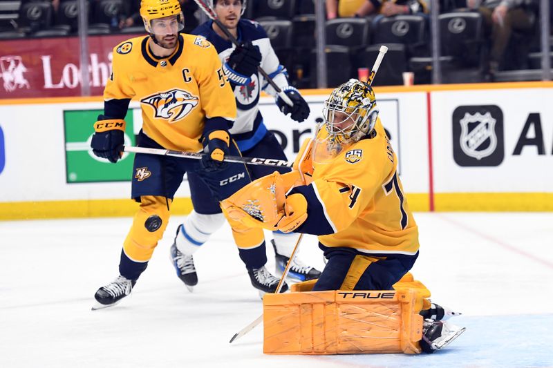 Apr 9, 2024; Nashville, Tennessee, USA; Nashville Predators goaltender Juuse Saros (74) makes a save during the second period against the Winnipeg Jets at Bridgestone Arena. Mandatory Credit: Christopher Hanewinckel-USA TODAY Sports