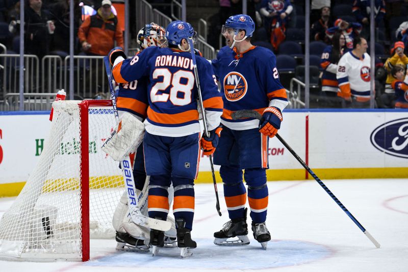 Dec 7, 2023; Elmont, New York, USA; New York Islanders goaltender Semyon Varlamov (40) is greeted by New York Islanders defenseman Alexander Romanov (28) and New York Islanders left wing Anders Lee (27) after defeating the Columbus Blue Jackets at UBS Arena. Mandatory Credit: John Jones-USA TODAY Sports