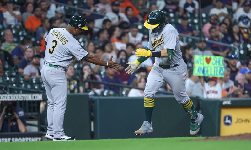 Sep 11, 2023; Houston, Texas, USA; Oakland Athletics catcher Shea Langeliers (23) celebrates with third base coach Eric Martins (3) after hitting a home run during the seventh inning against the Houston Astros at Minute Maid Park. Mandatory Credit: Troy Taormina-USA TODAY Sports